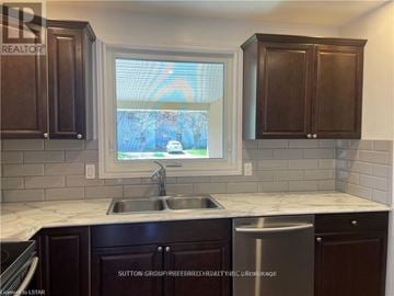 London North (North F) multi-family for rent - A kitchen with dark brown cabinets and a white countertop.