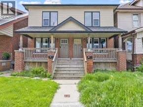 Windsor duplex for rent - A house with a front porch and a green lawn.