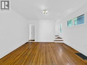 Windsor duplex for rent - A room with wooden flooring and white walls.