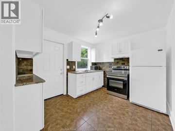 Windsor apartment for rent - A kitchen with white cabinets and a tiled floor.