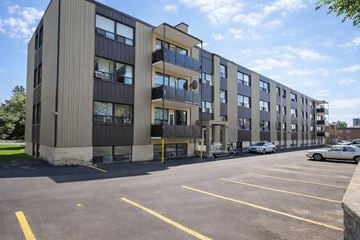 Toronto apartment for rent - A large building with a parking lot in front of it.