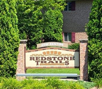 Green Bay apartment for rent - A sign that says Redstone Trails in front of a building.