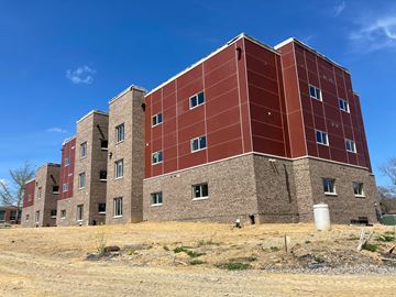 Blacksburg apartment for rent - A large red brick building with a flat roof and a chimney on the left side.