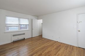 Edison apartment for rent - the living room of an apartment with wood floors and white walls