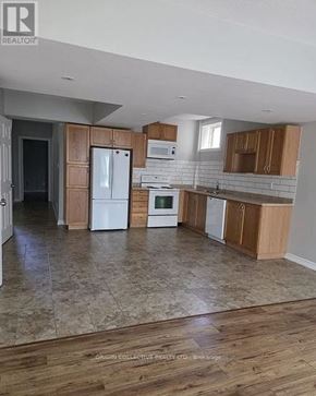 Barrie (Edgehill Drive) apartment for rent - A kitchen with wooden cabinets and a tiled floor.