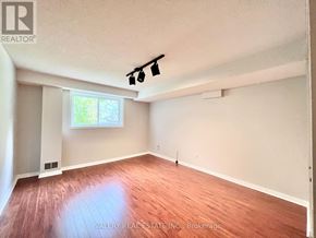 Toronto (Centennial Scarborough) apartment for rent - A room with wooden flooring and a window letting in natural light.