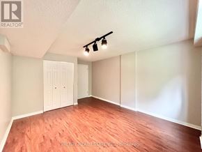 Toronto (Centennial Scarborough) apartment for rent - A room with wooden flooring and a white door.