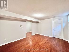 Toronto (Centennial Scarborough) apartment for rent - A room with wooden flooring and a white door.