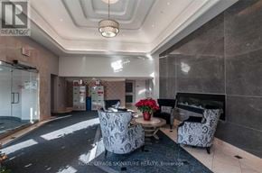 Richmond Hill (Beaver Creek Business Park) condo for rent - A well-lit hallway with a table and chairs in the middle.