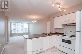 Richmond Hill (Beaver Creek Business Park) condo for rent - A white kitchen with a refrigerator, stove, and sink.