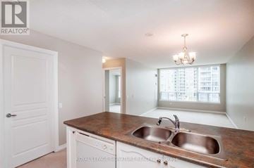 Richmond Hill (Beaver Creek Business Park) condo for rent - A kitchen with a sink and a chandelier.
