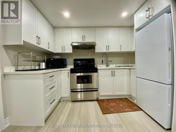 Mississauga (Erin Mills) apartment for rent - A kitchen with white cabinets and appliances.