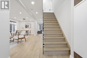 Hamilton (Gilkson) apartment for rent - A staircase in a house with a logo of RE/MAX Escarpment Realty Inc. on the wall.