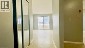 Kitchener condo for rent - A room with a sliding glass door leading to a balcony.