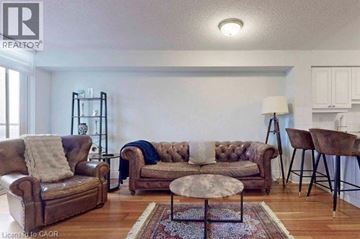 Toronto condo for rent - A living room with a brown leather couch and a round table.