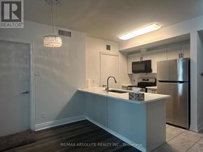 Ottawa condo for rent - A kitchen with a sink, stove, and refrigerator.