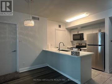 Ottawa condo for rent - A kitchen with a sink, stove, and refrigerator.