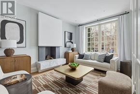 Toronto (Annex) apartment for rent - A living room with a white couch, a coffee table, and a fireplace.