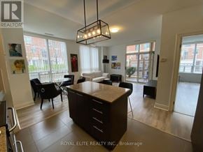 Markham (Commerce Valley) condo for rent - A well-lit, spacious kitchen and dining area with a large island in the middle.