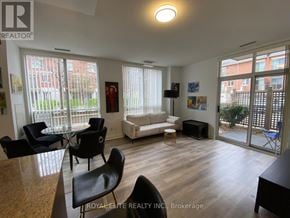 Markham (Commerce Valley) condo for rent - A living room with a couch, chairs, and a table.