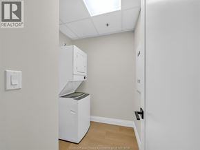 Windsor apartment for rent - A white room with a small refrigerator and a cabinet on top of it.