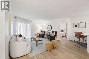 Windsor condo for rent - A living room with a white sofa and a wooden coffee table.
