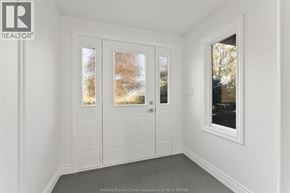 Woodslee apartment for rent - A white interior with a door and a window.