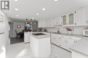 Woodslee apartment for rent - A kitchen with white cabinets and a large island.