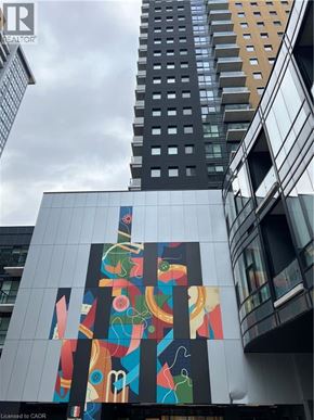 Kitchener condo for rent - A tall building with a colorful mural on its side.