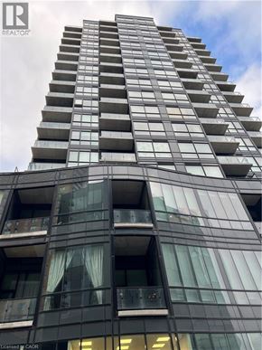 Kitchener condo for rent - A tall building with balconies and windows is shown in the image.
