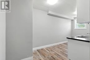 London East (East K) multi-family for rent - A white room with a window and a sink.