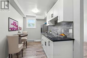 London East (East K) multi-family for rent - A kitchen with a table and chairs and a painting of flowers on the wall.