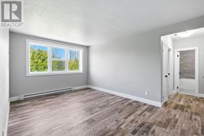 London East (East K) multi-family for rent - A room with a large window and a wooden floor.