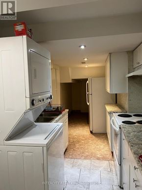 Brampton (Bramalea North Industrial) apartment for rent - A kitchen with white appliances and cabinets.