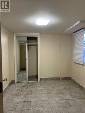 Brampton (Bramalea North Industrial) apartment for rent - A room with a tiled floor and a doorway leading to another room.
