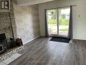 Barrie (Cundles East) apartment for rent - A room with a fireplace and a TV on the left side.