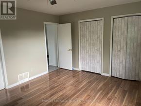 Barrie (Cundles East) apartment for rent - A room with wooden floors and three doors.