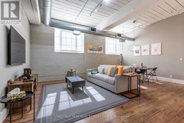 Toronto (South Riverdale) apartment for rent - A living room with a grey couch and a coffee table.