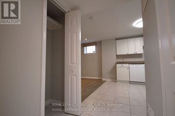 Brampton (Fletcher's Meadow) mobile home for rent - A white doorway leads to a kitchen with white cabinets and a white dishwasher.