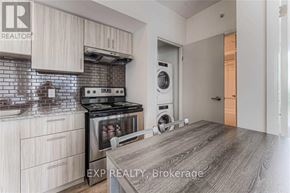 Waterloo condo for rent - A kitchen with a stove top oven and a dishwasher.