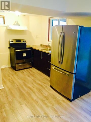 Aurora (Aurora Grove) apartment for rent - A modern kitchen with a stainless steel refrigerator and a black oven.