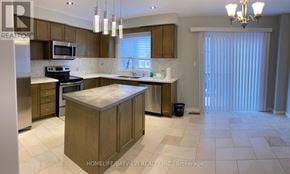 Markham (Berczy) townhouse for rent - A kitchen with a refrigerator, microwave, and a dining table.