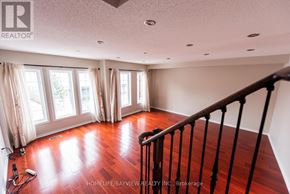 Markham (Berczy) townhouse for rent - A room with wooden floors and a sliding glass door.