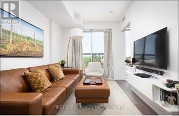 Toronto (Kensington-Chinatown) condo for rent - A living room with a brown leather couch and a television on the wall.