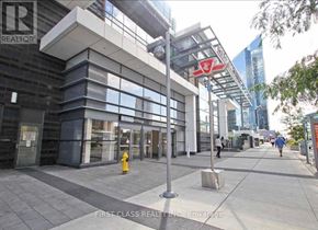 Toronto (Willowdale East) condo for rent - A modern building with a glass facade and a red sign that says "REALTOR".