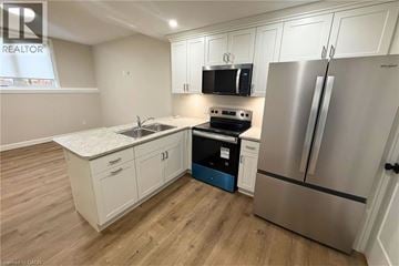 Woodstock apartment for rent - A kitchen with a stove, refrigerator, and cabinets.