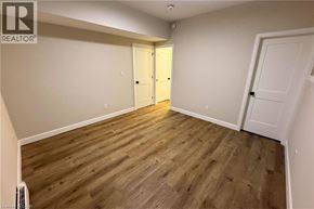Woodstock apartment for rent - A room with wooden flooring and two doors.