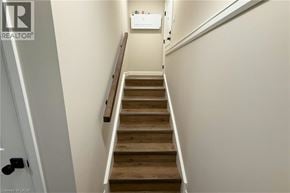 Woodstock apartment for rent - A staircase with wooden steps and white walls.