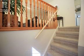 London North (North I) apartment for rent - A staircase with a wooden banister and a carpeted runner.