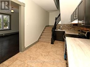 Ottawa apartment for rent - A room with a staircase leading to the upper floor.